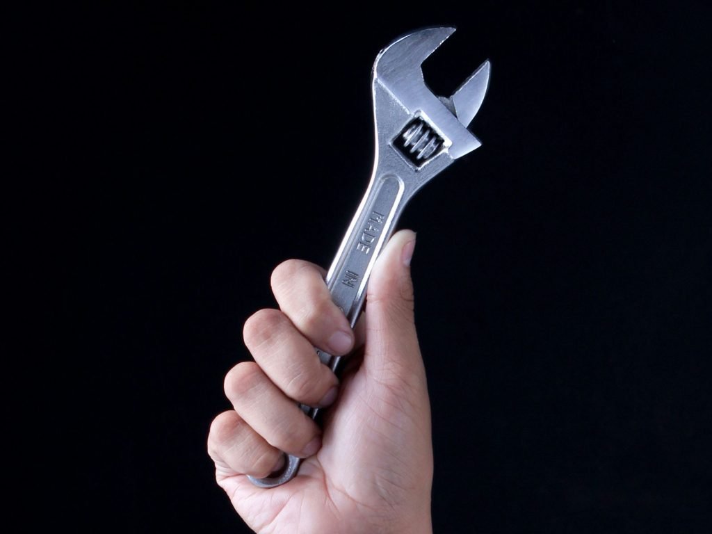 Person holding a tool as EDOTCO Group has built an AI chatbot, NaPA GPT, on Microsoft Azure to speed up decisions on where new mobile towers go.